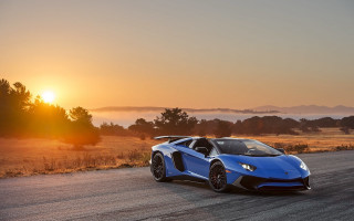 Blue sports car sunset road 2 - the sun setting behind free wallpaper