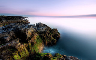 Rocky cliff lake sunset pink - a purple hue free wallpaper