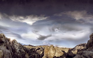 Mountain landscape rocks cloudy sky - a mountain landscape free wallpaper