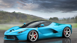Blue sports car wet road - the background and a mountain in the distance free wallpaper