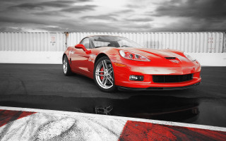 Red sports car parking lot 26 - a cloudy sky in the background free wallpaper