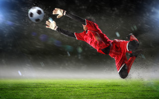 Soccer player red uniform kicking - his foot free wallpaper