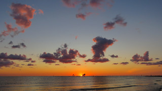 Sunset beach boat clouds horizon - a beach in the foreground free wallpaper