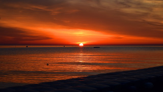 Sunset ocean boat clouds dusk 2 - a boat in the distance free wallpaper