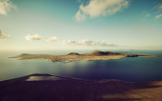Small island mountain clouds ocean - a small island in the middle of a body free wallpaper