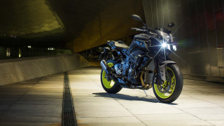 Motorcycle parked sidewalk building night - its light free wallpaper