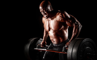 Muscular man barbell black background - bruce onobrakpeya free wallpaper