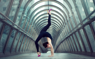 Woman handstand glass ceiling arches - symmetric balance free wallpaper