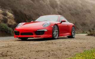 Red sports car mountain dirt - a foggy sky in the background free wallpaper for desktop