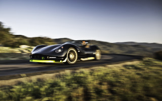 Black sports car green hillside 3 - a black sports car free wallpaper