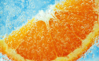 Orange slice bubbles blue sky - an orange slice free wallpaper