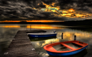 Docked boat lake sunset sky - dramatic free wallpaper