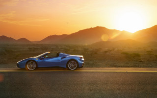 Blue sports car sunset mountains - a bright sun in the sky free wallpaper
