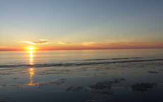 Sunset ocean beach surfboard mountain - the beach in the distance free wallpaper