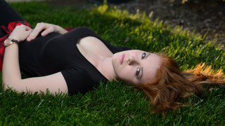 Woman laying on grass blurry 2 - claire falkenstein free wallpaper