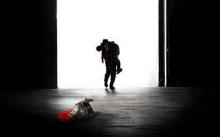 Person walking dark room backpack - christian w. staudinger free wallpaper