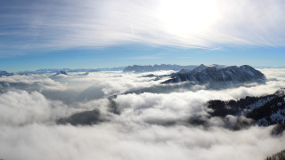 Mountain range clouds sun reflection - a view of a mountain range free wallpaper for desktop