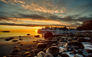 Sunset rocky beach boat snow - a boat in the distance free wallpaper