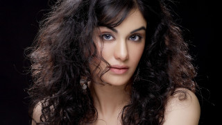 Woman long hair blue eyes 19 - a black background behind her free wallpaper for desktop