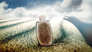 Sand bottle beach cloudy sky - a sandy beach under a cloudy sky free wallpaper