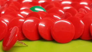 Red buttons green surface leaf - a green surface free wallpaper