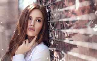 Eszter mattioni portrait snowy fence - a woman leaning against a fence free wallpaper