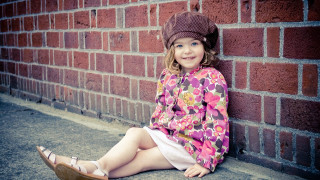 Little girl brick wall smiling - her hat free wallpaper