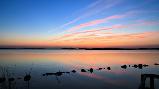 Sunset lake rocks dock clouds - a dock in the foreground free wallpaper