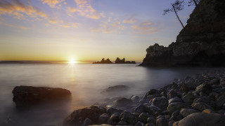 Sunset rocky beach lake mountain - a large body of water free wallpaper
