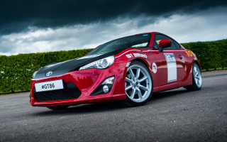 Red sports car cloudy sky 10 - colin hayes free wallpaper