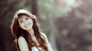 Woman long hair smiling forest - free portrait wallpaper for desktop