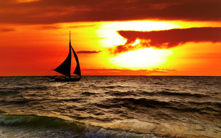 Sailboat ocean sunset clouds horizon 2 - a sailboat free wallpaper