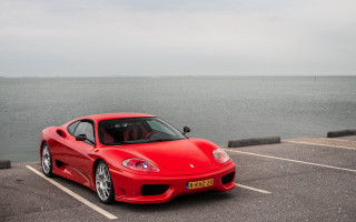 Red sports car ocean parking - free cars wallpaper