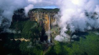 Mountain cliff clouds waterfall forest - a view of a mountain free wallpaper