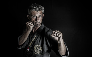 Man raising fists black shirt - his fist free wallpaper