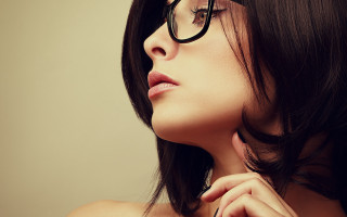 Woman glasses necklace looking up - head and shoulders portrait free wallpaper