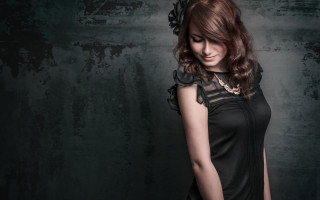 Woman black dress portrait fashion - a gray wall behind her free wallpaper