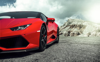 Red sports car mountains clouds - a parking lot free wallpaper
