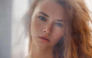 Woman freckled hair serious look - her face and shoulder free wallpaper