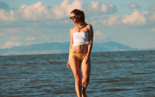 Woman bikini surfboard mountain ocean - a surfboard in the ocean free wallpaper