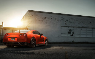 Red sports car backlit building - the sun shining behind free wallpaper
