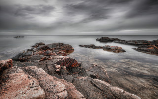 Rocky shore mountainous horizon moody - a dark sky free wallpaper