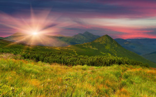 Sunset mountain range sunbeam clouds 2 - a beautiful sunset over a mountain range free wallpaper