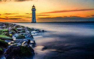 Lighthouse rocky shore sunset water 3 - arthur quartley free wallpaper