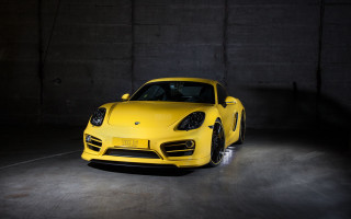 Yellow sports car dark garage - a concrete wall behind free wallpaper