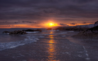 Sunset ocean waves rock formation - a rock formation in the foreground free wallpaper