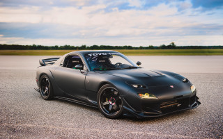 Black sports car cloudy sky - a black sports car free wallpaper