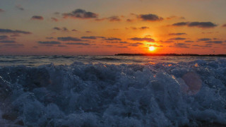 Sunset ocean waves island lighthouse - a lighthouse in the distance free wallpaper