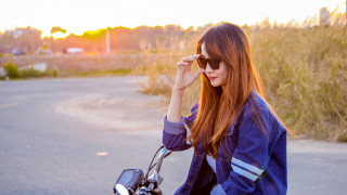 Red haired girl motorcycle sunset - grass and bushes free wallpaper