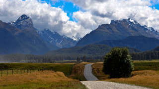 Dirt road mountains cloudy sky 2 - free landscape wallpaper
